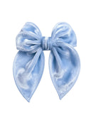 The Twinkle Toes Lauren Velvet Bow in a shimmering pastel that catches the light with every twirl.